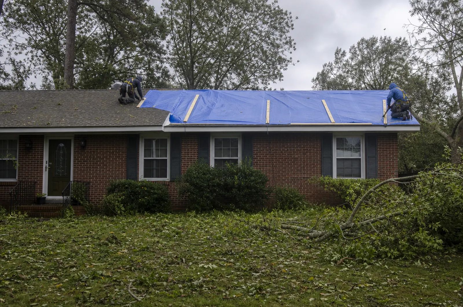 Emergency Roof Repair in Charleston, SC: emergency roof tarping on a brick ranch home after a storm near Charleston
